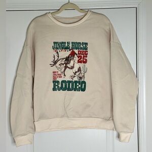 Cream Christmas sweatshirt with a super cute rodeo design